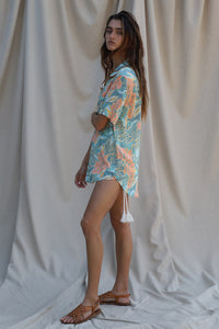 blue, green, and peach floral print shirt