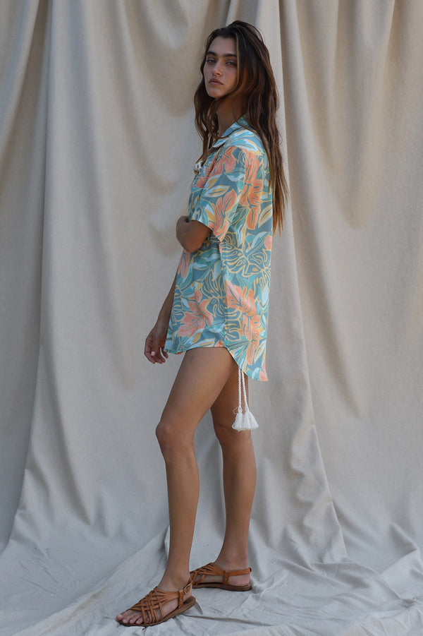 blue, green, and peach floral print shirt