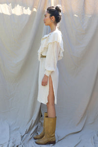 ruffle collar detail extends around the entire neckline