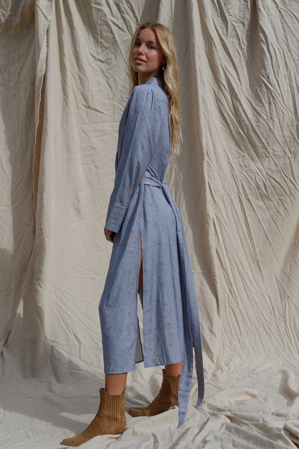 side shot of dress shown tie tied behind back