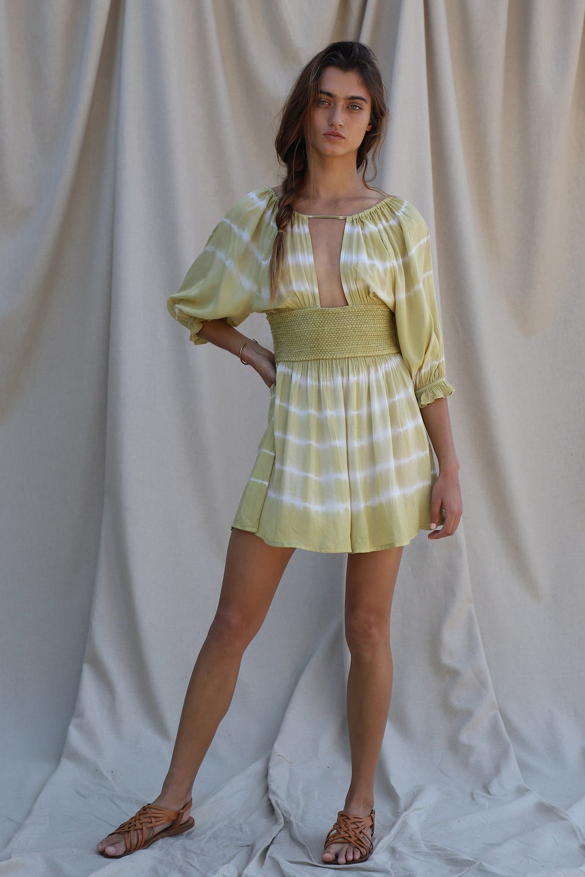 3/4 sleeve green and white tie dye mini dress with smocked waist detailing and a keyhole bodice