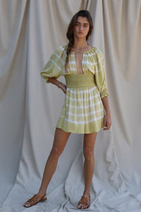 3/4 sleeve green and white tie dye mini dress with smocked waist detailing and a keyhole bodice