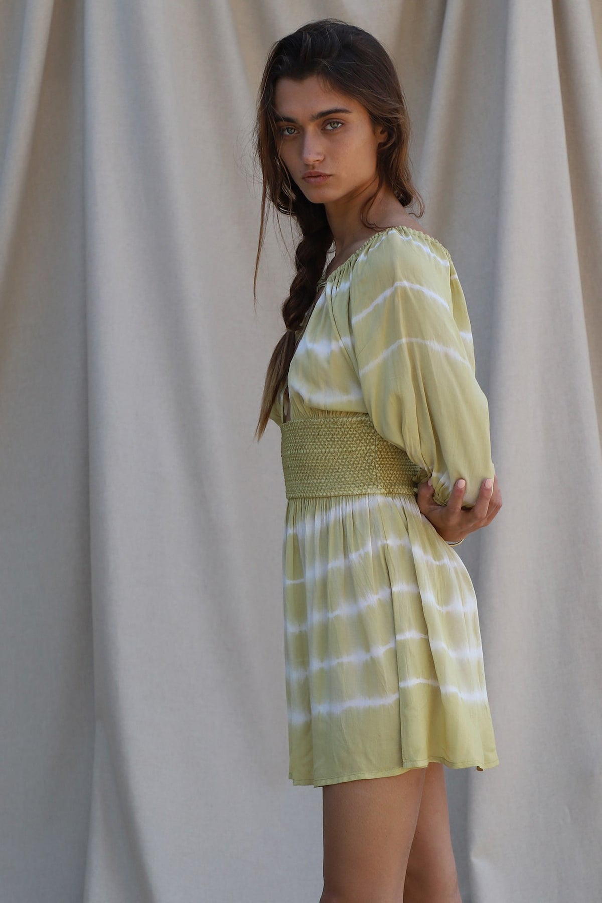 green and white mini dress shown from side