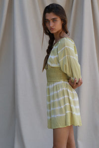 green and white mini dress shown from side